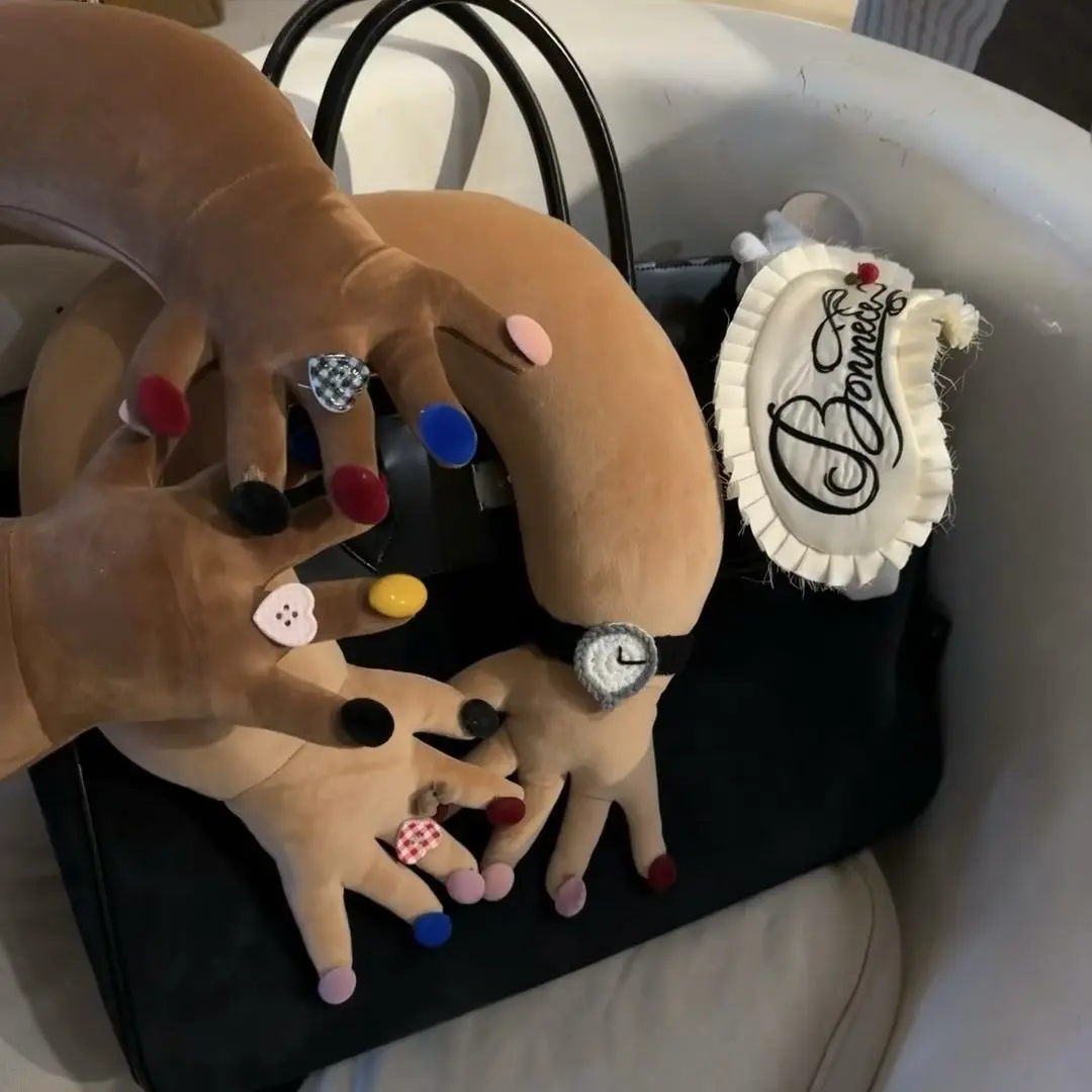 Quirky "Interlocked Fingers" U-shaped neck pillow—a plush toy featuring a playful, "so-ugly-it's-cute" design; an inventive, trendy accessory perfect for Instagram.