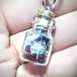 Quartz Crystals and Garnetts in a small bottle pendant necklace.