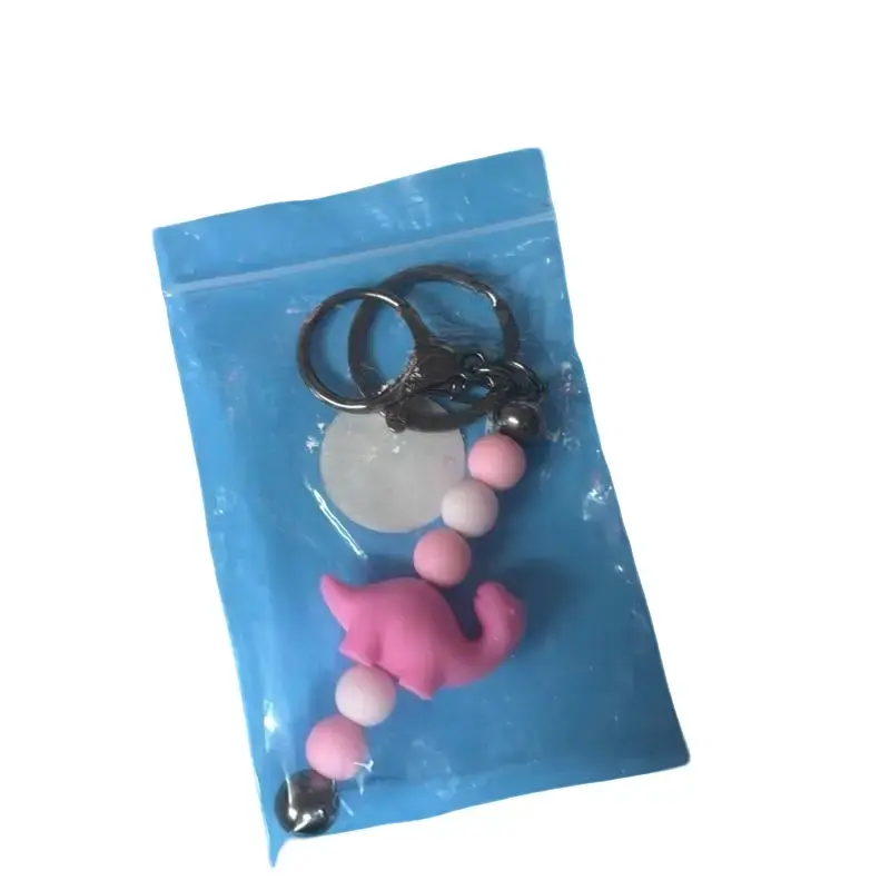 Pink Dinosaur Keychain with Beaded Strap in Clear Packaging
