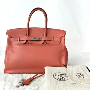Pre-owned HERMÈS Birkin 35 in Earth Orange Swift leather, with lock and keys. Year 2008 (L stamp). Model number N21320842.