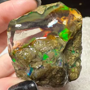 Ethiopian Water Opal Specimen rainbow play of color with clear base in between light grey matrix