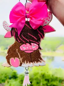 Highland Cow Car Freshie with Pink Bow and Tassel Decorative Accessory for Car Enthusiasts Unique Quirky Design Whimsical and Eye-Catching Display 3.5" x 2.75" x 0.8"