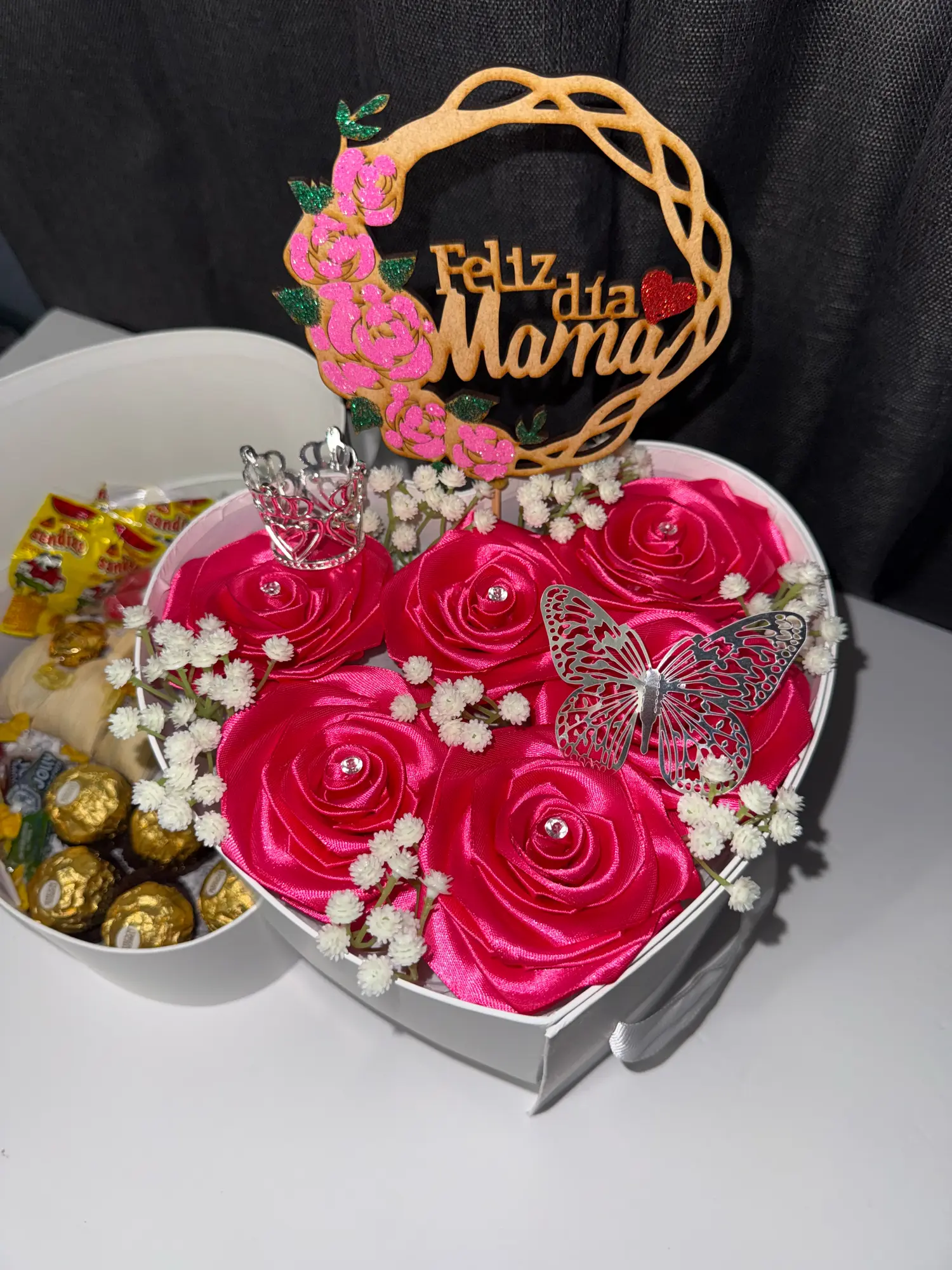 Natural Roses Eternal Roses Feliz Dia De La Madre Heart-Shaped Box with Butterfly Accent and Candy Arrangement