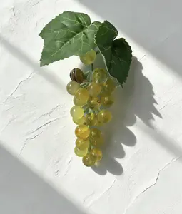 decorative item in the shape of grapes made from yellow fluorite