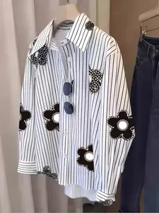 A ladies' fashion white and black striped sequined floral shirt, featuring refreshing vertical stripes paired with sequined floral designs. Suitable for office wear, shopping, outings, and indoor or outdoor outfits