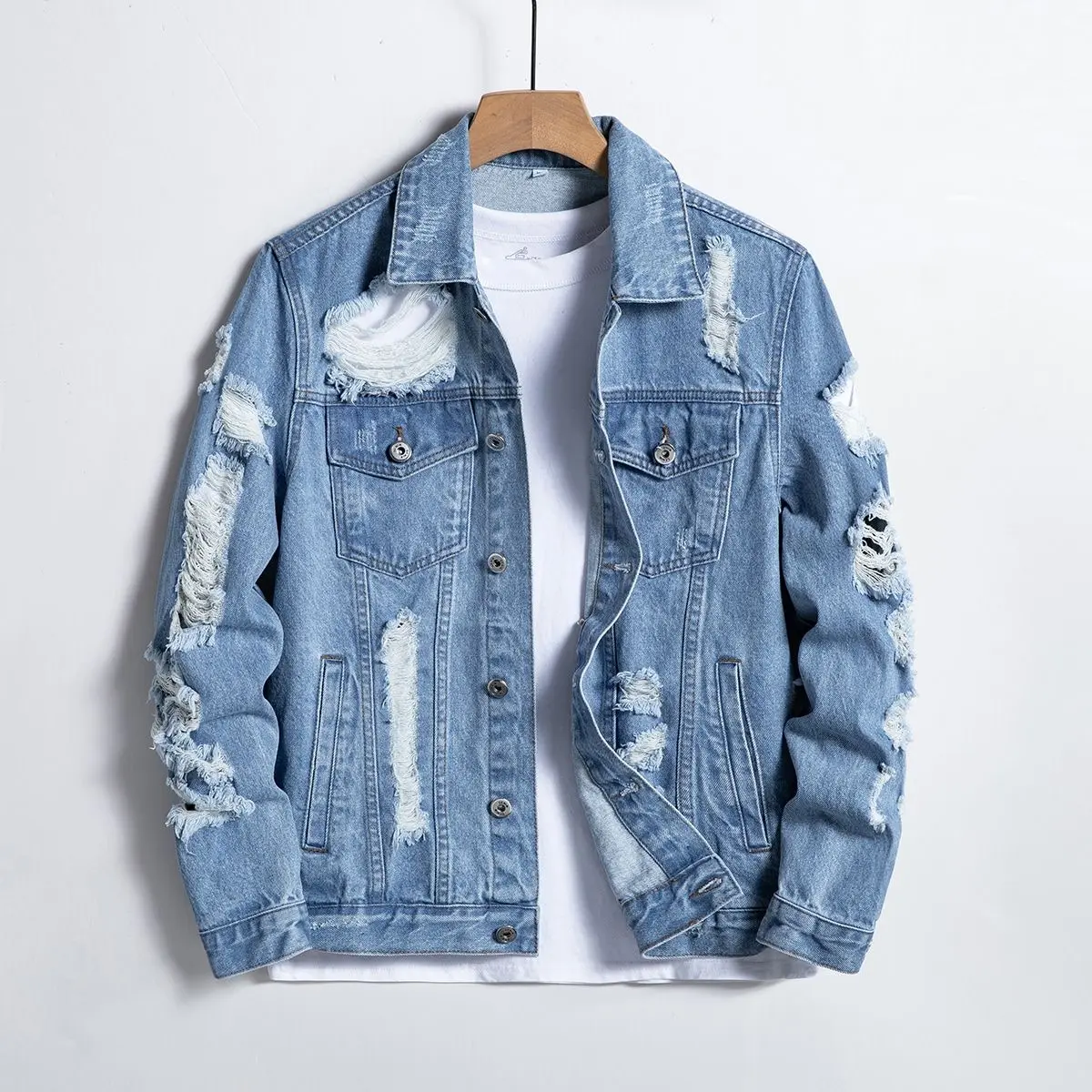 One men’s denim jacket in light blue with a hole; urban casual style featuring a turn down collar and button design, paired with large holes and frayed edges. The denim fabric drapes well and has structure—ideal for city men’s everyday commuting, casual w