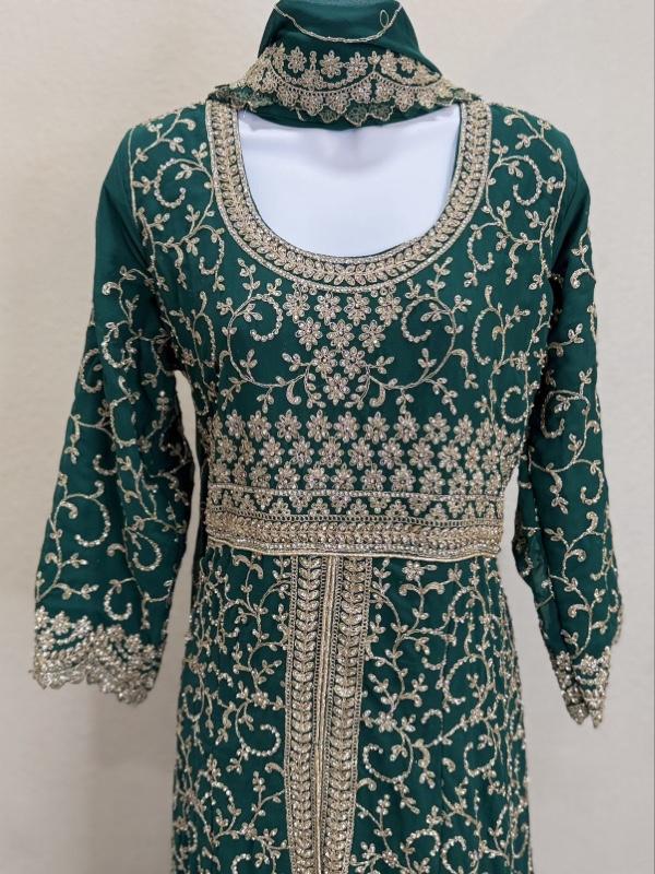 This image shows a green designer heavy embroidered bridal lehenga or Anarkali suit suited for traditional Indian weddings. Womenswear