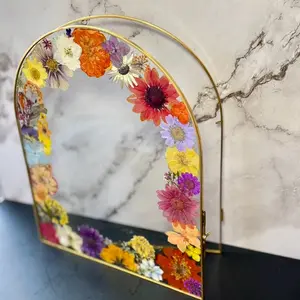 Dried pressed flowers arrangement on gold frame