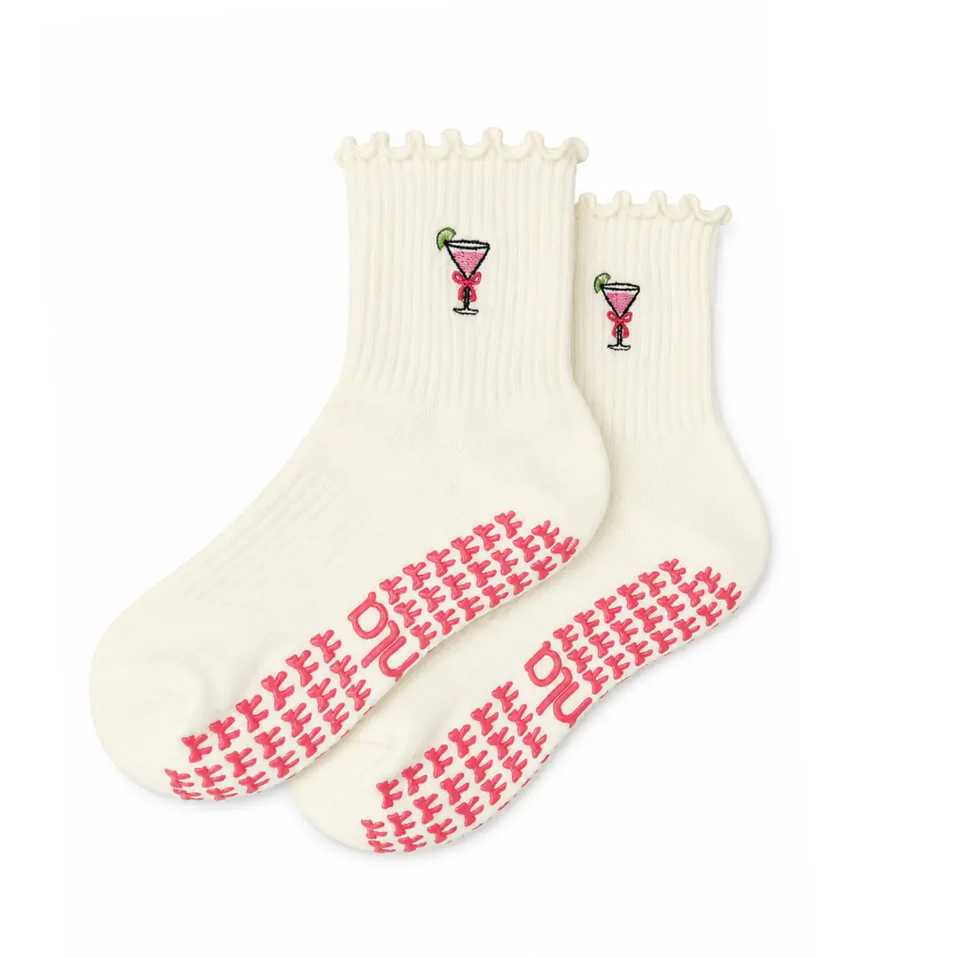 Cosmopolitan Grip Sock with pink cosmo embroidery and bow-shaped grips for Pilates, Barre, Lagree, and Yoga