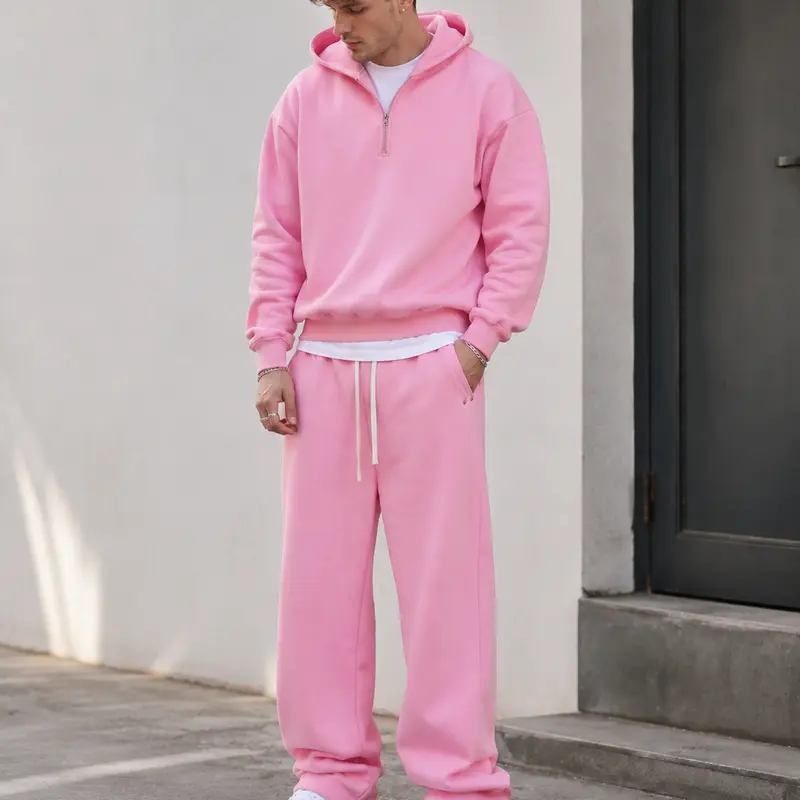 Men’s casual athletic half-zip hoodie sweatshirt and sweatpants set, two-piece streetwear outfit with a loose fit and soft fleece fabric.