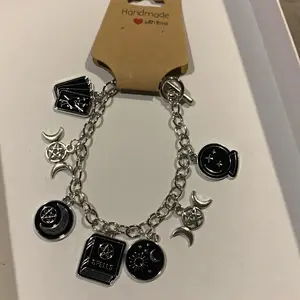 Handmade Book of Spells Charm Bracelet with Silver-Toned Design and Unique Charms, Featuring Various Magical Symbols