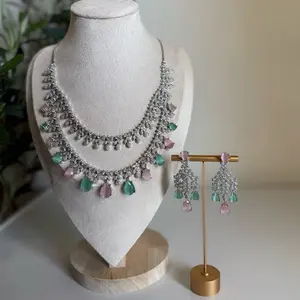 crystal bloom jewelry set  a breathtaking blend of pastel pink and mint green teardrops, outlined with fine silver brilliance. designed to elevate every bridal or festive look with timeless sparkle.   details: • includes: necklace + matching earrings