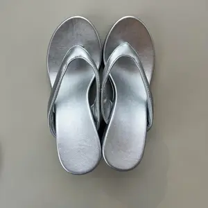 Silver metal wedge slide sandals with soft cushioning and anti-slip soles for summer outdoor wear. Lightweight slip-on design for easy wear and removal, ideal for beach vacations, pool parties, and everyday casual outings. Striking metallic texture comple