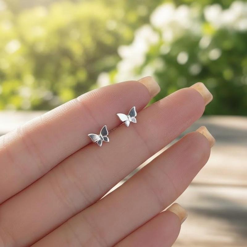 SunFeel The "Clean Girl" Essential: Minimalist Butterfly stud earrings for the ultimate effortless look. Upgrade your daily stack with these Copper Butterfly Studs. The perfect "Clean Girl" aesthetic.