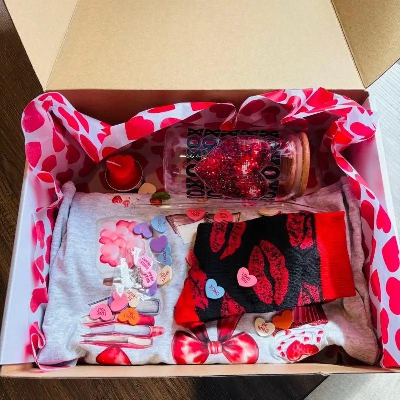 Valentine’s Day Mystery T-shirt Box with Libby Cup, Socks, Earrings & Candle - Assorted Colorful Items in Red and White Packaging