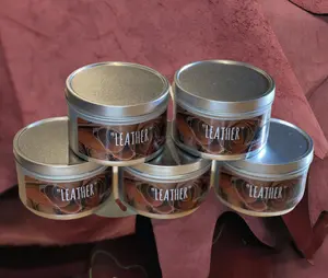 Leather Scented Candle. The candle is 100% soy wax and is in a 8oz tin container. the label is metallic. This is a 100% USA made product from Crafty American