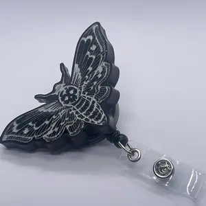 Black and silver deadhead moth badge reel