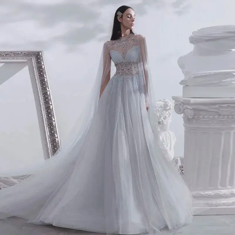 Silvery Oasis: Dubai-Inspired Crystal-Embellished Evening Gown with Elegant Cape - The Premier Choice for Arabic Proms, Weddings, and Grand Celebrations.