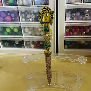 Beautiful Gold Cuckoo Clock on a Rhinestone Beaded Pen with Elegant Design and Decorative Beads