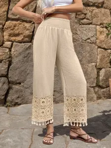 Elegant autumn-winter peach-colored trousers with elastic waistband and a design of spliced lace fringes on the legs, suitable for outdoor outings, work or commuting.