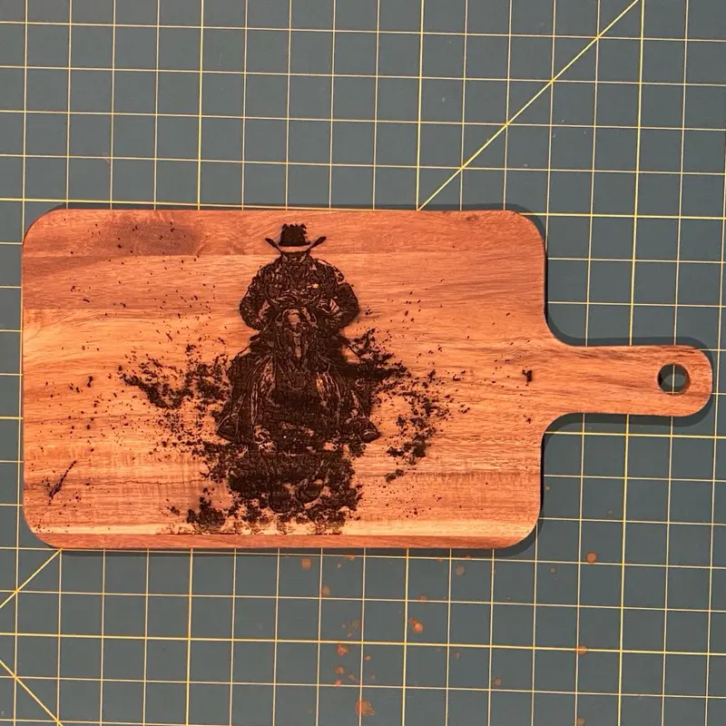 Cowboy Riding Through Water On Horseback Cutting Board