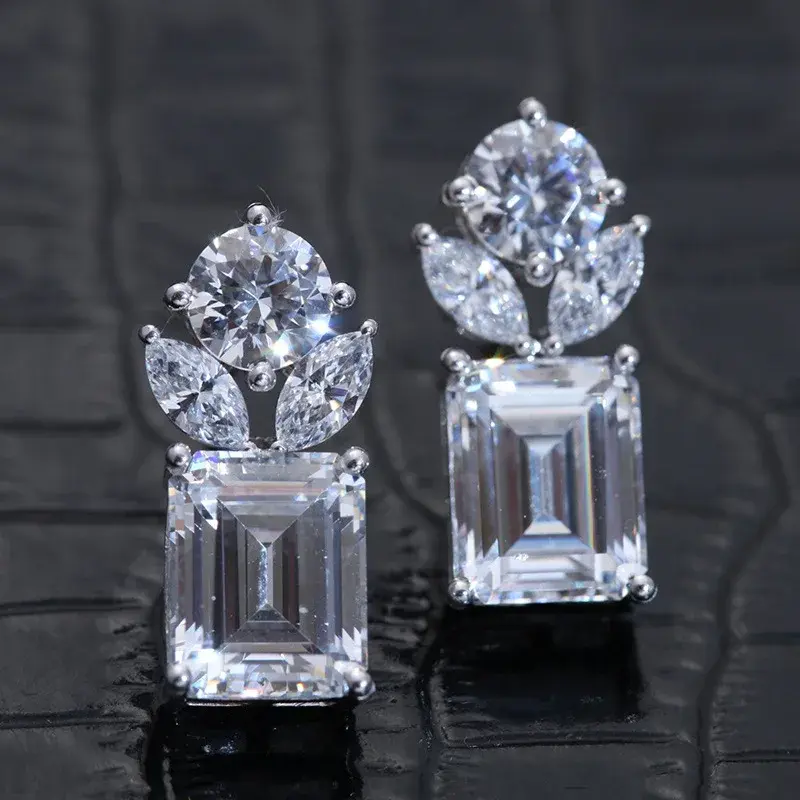 Kosmée emerald cut zirconia stone dangle stud earrings.