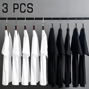 Best-selling 3-pack for better value. Black and white pure cotton men’s short-sleeve T-shirts—loose fit with a premium feel, solid color minimalist basic tee, 180 g/m² cotton fabric, set-in shoulders, crew neck basic model men’s T-shirt.