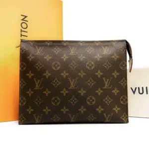 Pre-owned Louis Vuitton Canvas Clutches & Wristlets Toilette 26 Poche Monogram Wallet Brown