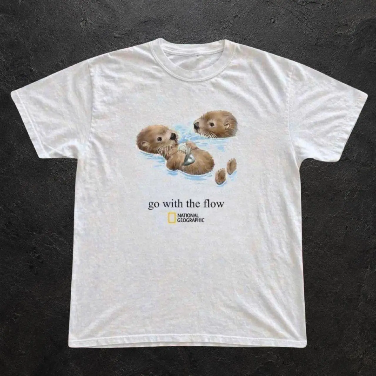 National Geographic white t-shirt with graphic of two otters in water with the words 'go with the flow'- Gildan unisex reprinted t-shirt TU