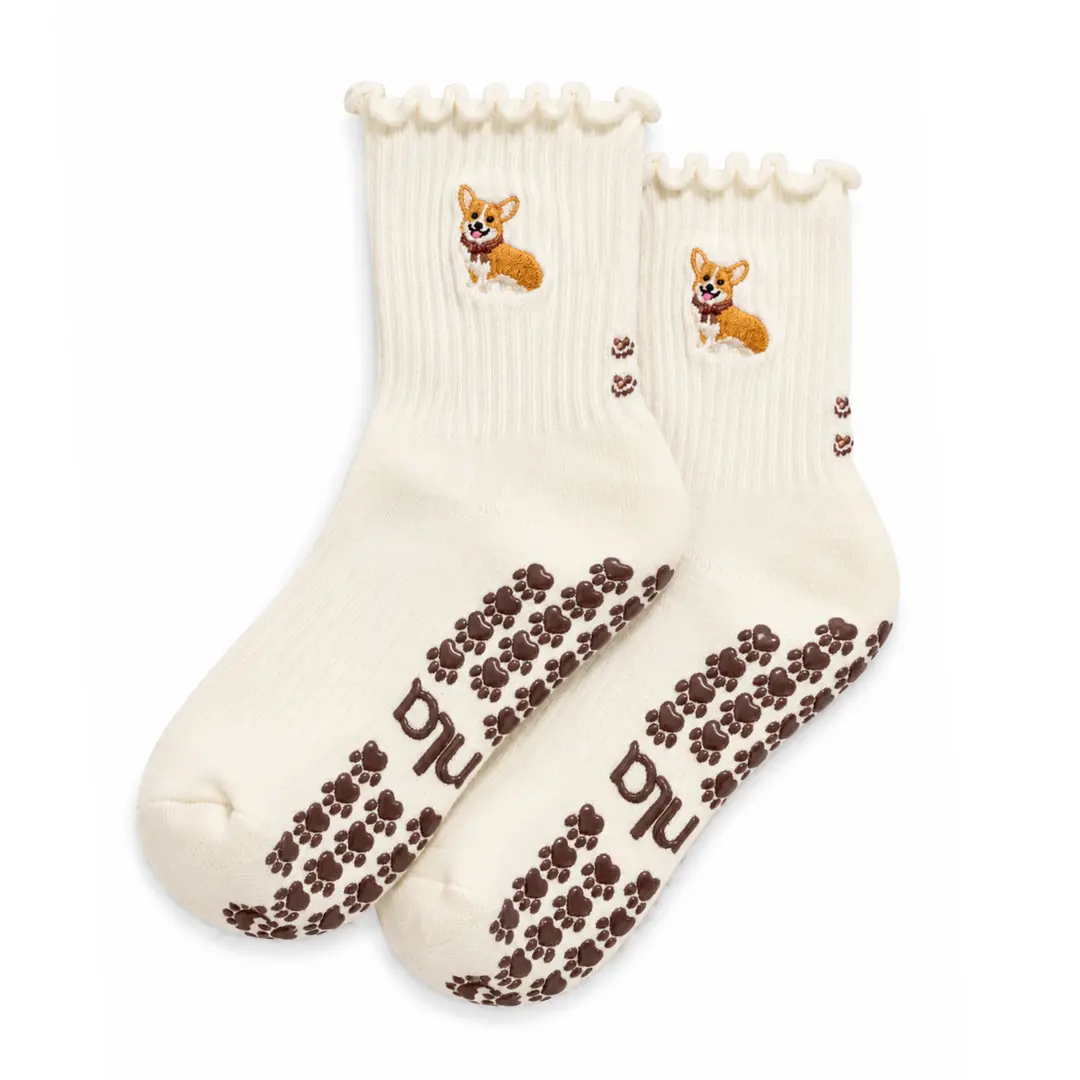 The Corgi Embroidery Grip Sock with chocolate-brown paw-print grips for Pilates, Barre, Lagree, and Yoga