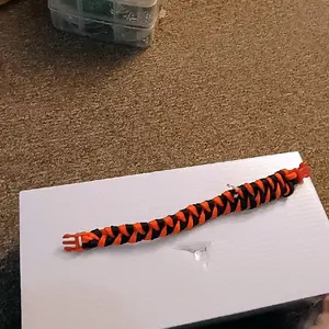 Paracord Bracelet - Orange and Black Color Scheme on White Surface Product Image