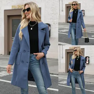 Women’s winter wool blend camel-colored mid-length jacket with a slit, double-breasted lapels, and a casual button closure; elegant fit, minimalist design with a blue collar. GARMENTARY