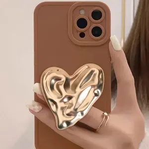 A metal phone stand with a heart-shaped wave design, featuring an asymmetrical design suitable for various phone cases.