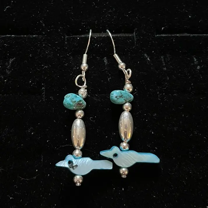 Navajo handmade sterling silver hook earrings adorned with chinese turquoise, a bird-shaped blue mother-of-pearl bead, liquid silver, and sterling silver beads.