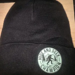 Hide and Seek Champion Beanie - Black Knit Hat with Forest Logo for Outdoor Enthusiasts