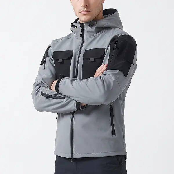 Men’s gray-and-black color-block tactical hooded softshell jacket with multiple pockets; abrasion-resistant and windproof; suitable for outdoor commuting, hiking, and mountaineering.