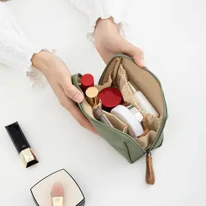 Who gets it?! This minimalist makeup bag is chef’s kiss! That olive green is so high-end  Zipper + wrist strap, super easy to grab stuff when you’re out