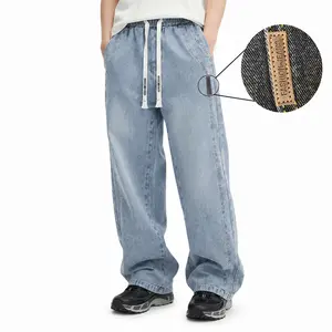 Men’s washed jeans with an elastic waistband featuring lettered drawstring; loose, versatile wide-leg casual pants suitable for all seasons, ideal for everyday wear and a clean, neat look.