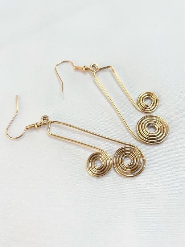 SCS-MTER-002 Golden Metal Echo 2” Earrings with Spiral Design and Hook Closure SCS-MTER-002 Golden Metal Echo 2” Earrings with Spiral Design and Hook Closure