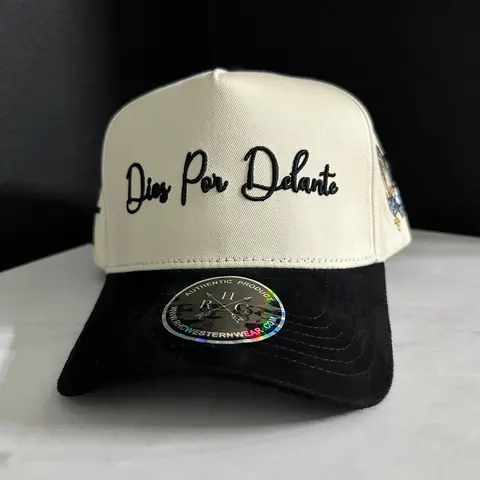 Dios Por Delante Hat with Embroidered Text, Adjustable Fit, Adjustable Strap, and Black Lace Detail