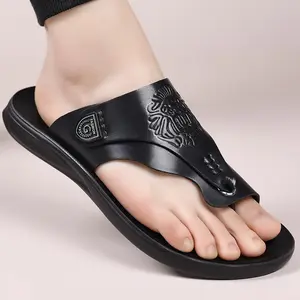 Men’s black flip-flops featuring a textured upper and minimalist metal buckle details; their sleek, sophisticated design blends quality and casual style—ideal for summer footwear.