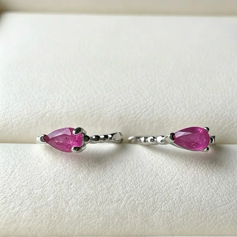 <PingEast jewelry > Delicate and dazzling — these 925 sterling silver huggie earrings showcase 2mm teardrop-shaped natural rubies, perfect for adding a touch of refined elegance to any look