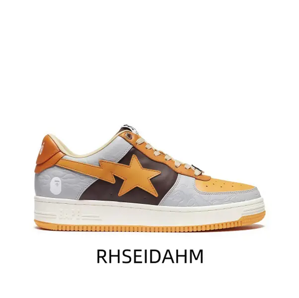 Eye catching grey brown orange low top street sneaker, orange star design, grey brown panel accent, white midsole, orange outsole, lace up front, designer footwear