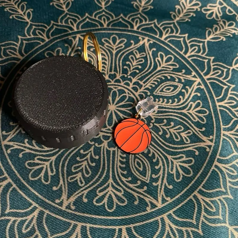 Phone dust plug (Type C) with basketball charm and keychain case.