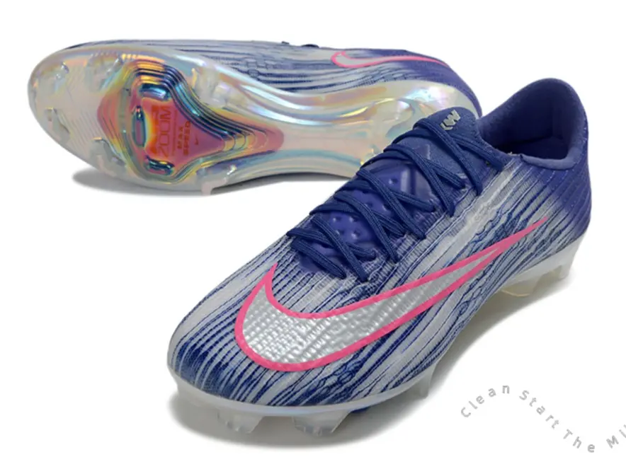 Pink Trim Silver Surface Curved Logo Navy White Gradient Vertical Stretch Knit Firm Ground Soccer Cleats, Iridescent Clear Cushion FG Stud Outsole Unisex Pro Footwear For Outdoor Natural Grass League Match