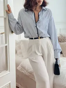 A women's blue and white striped loose shirt with a stylish design, the stripes look slim and not stuffy, suitable for commuting to work, shopping and outdoor activities, indoor and outdoor dressing