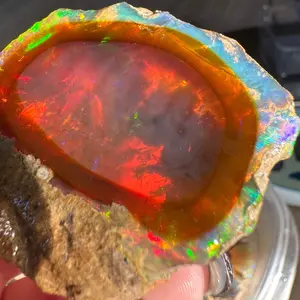 Ethiopian water Opal Specimen with both dark and clear base and trippy rainbow “fire”
