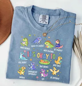 Comfort Colors Autism Awareness Dinosaur T-Shirt, It’s OK to Be Different Graphic Tee, Neurodiversity Shirt for Autism Moms, SPED Teacher Gift, Inclusion Shirt, Cute Unisex Cotton Top - ShamCren