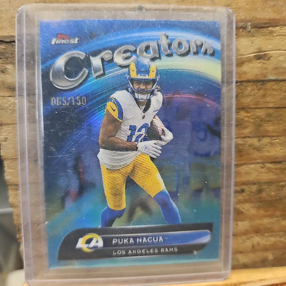 Product Name: Puka Nacua Topps Finest Creators Blue Parallel #55/150 – Rams