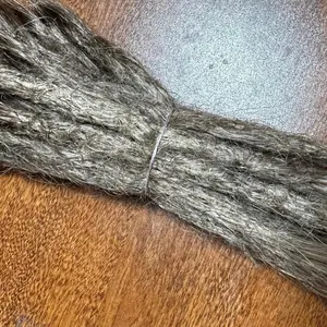 Human hair locs with loose ends medium brown ombré to dark blonde.